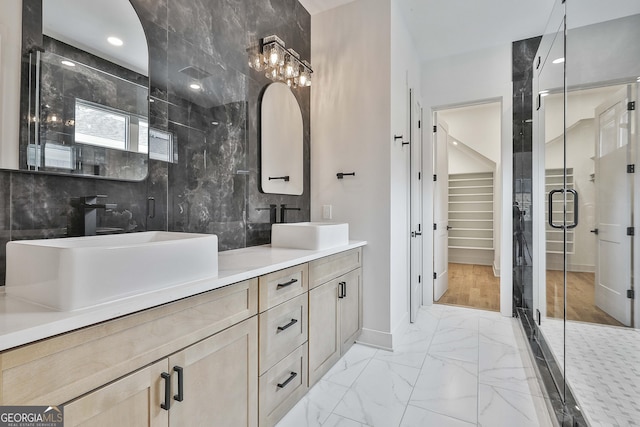 1240 Hayes Sq, Peachtree City, GA 30269 - full bath featuring marble look tile flooring, double vanity, a shower stall, baseboards, and a walk in closet