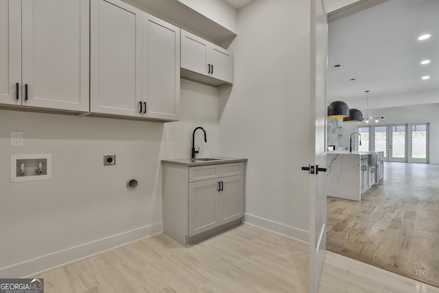 1240 Hayes Sq, Peachtree City, GA 30269 - laundry room featuring electric dryer hookup, washer hookup, baseboards, cabinet space, and recessed lighting