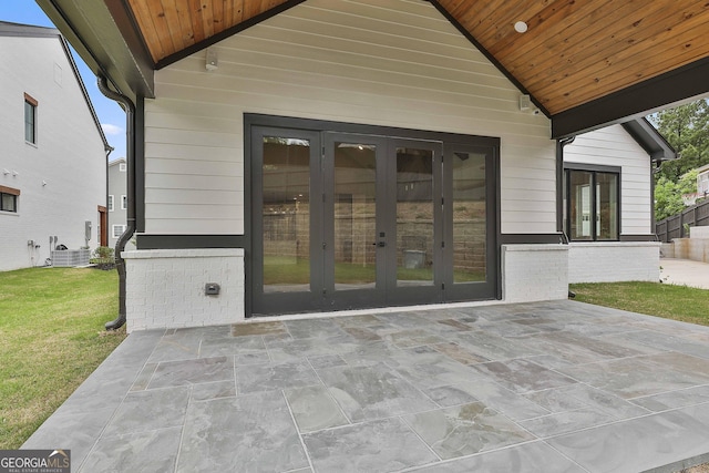 1240 Hayes Sq, Peachtree City, GA 30269 - doorway to property featuring french doors, a patio area, a lawn, and central AC
