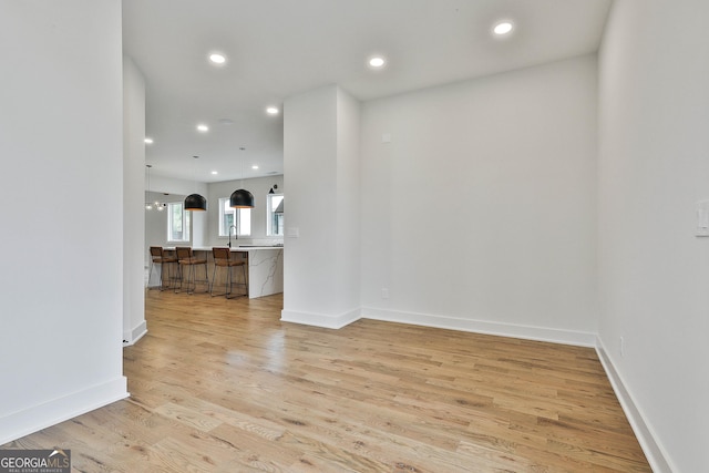 1240 Hayes Sq, Peachtree City, GA 30269 - unfurnished living room featuring recessed lighting, light wood-style floors, baseboards, and a sink