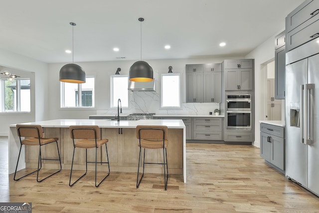 1240 Hayes Sq, Peachtree City, GA 30269 - kitchen featuring gray cabinets, appliances with stainless steel finishes, light countertops, backsplash, and recessed lighting
