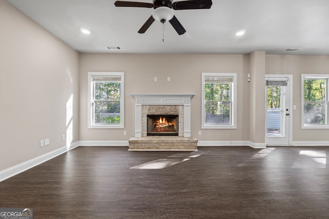 475 Louise Way, Locust Grove, GA 30248 - unfurnished living room featuring plenty of natural light, dark wood-type flooring, a brick fireplace, a ceiling fan, and recessed lighting