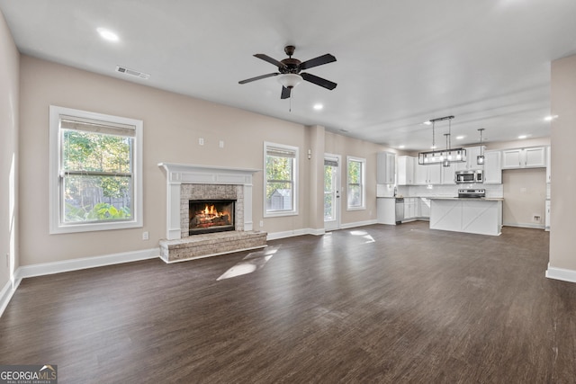 475 Louise Way, Locust Grove, GA 30248 - unfurnished living room featuring baseboards, a brick fireplace, a ceiling fan, recessed lighting, and dark wood finished floors