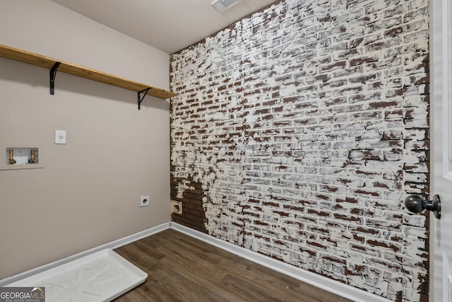 475 Louise Way, Locust Grove, GA 30248 - washroom featuring hookup for an electric dryer, dark wood-style floors, hookup for a washing machine, baseboards, and brick wall