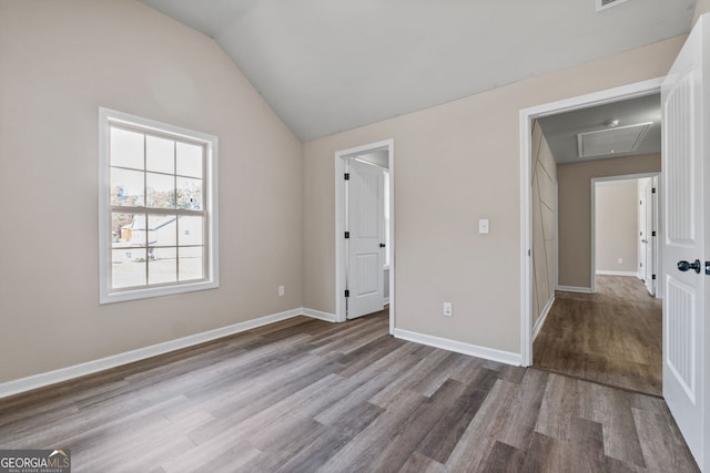 475 Louise Way, Locust Grove, GA 30248 - unfurnished bedroom with attic access, wood finished floors, vaulted ceiling, and baseboards