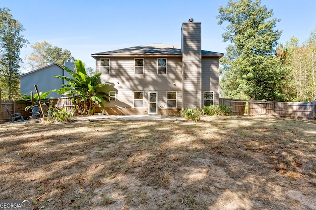 475 Louise Way, Locust Grove, GA 30248 - back of house with a chimney, a fenced backyard, and a patio