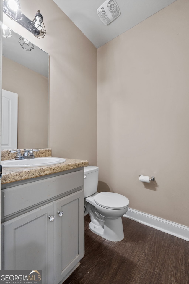 475 Louise Way, Locust Grove, GA 30248 - half bath with wood finished floors, toilet, vanity, and baseboards