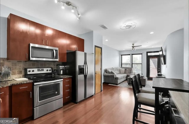 898 Oak St SW Unit 3204, Atlanta, GA 30310 - kitchen with stainless steel appliances, a ceiling fan, wood finished floors, decorative backsplash, and dark stone counters