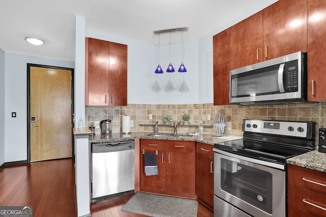 898 Oak St SW Unit 3204, Atlanta, GA 30310 - kitchen featuring stainless steel appliances, a sink, wood-type flooring, light stone counters, and decorative backsplash