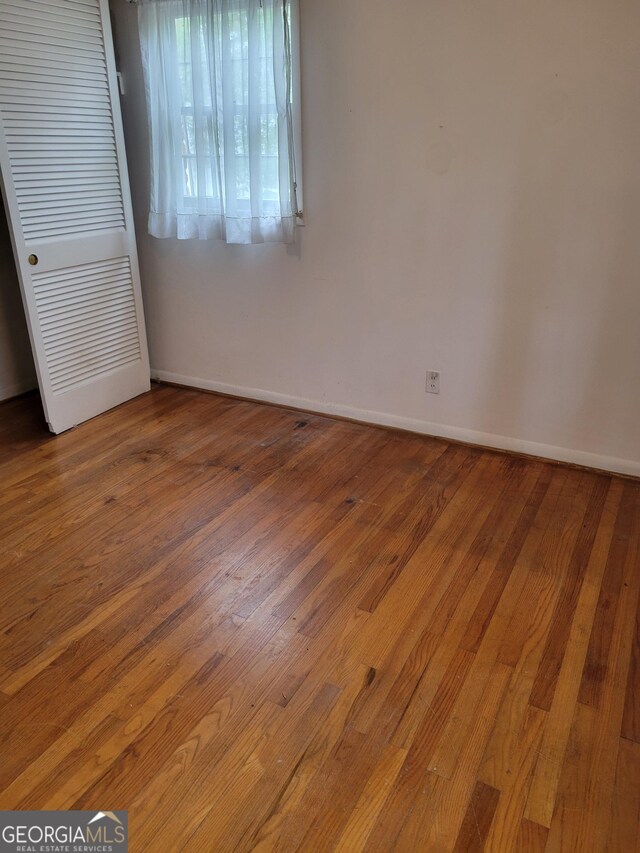 2137 Plantation Ln, Chamblee, GA 30341 - unfurnished bedroom with hardwood / wood-style floors, baseboards, and a closet