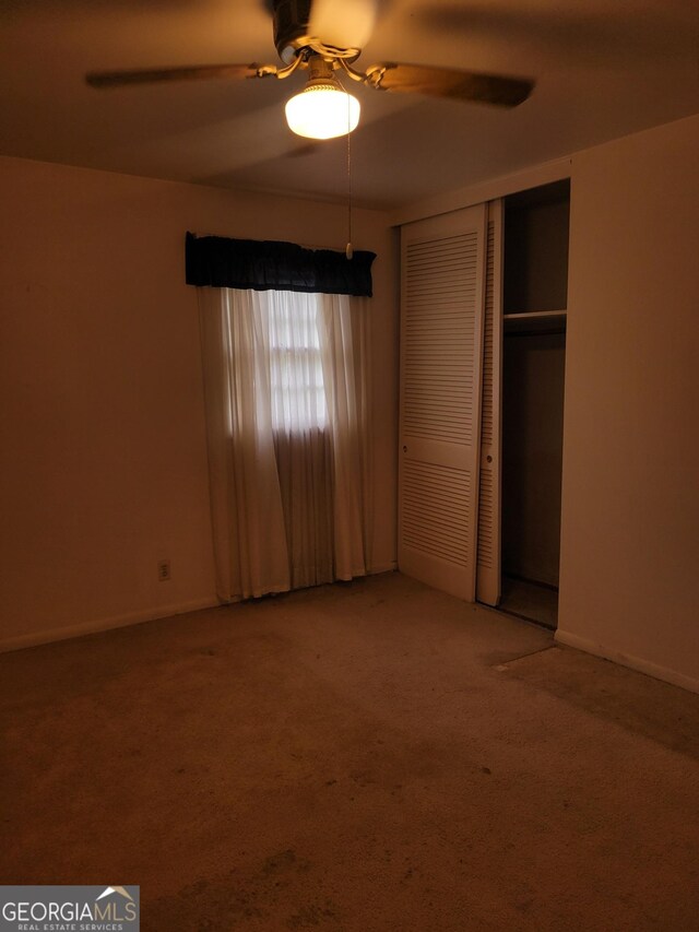 2137 Plantation Ln, Chamblee, GA 30341 - unfurnished bedroom with carpet flooring, a closet, baseboards, and a ceiling fan