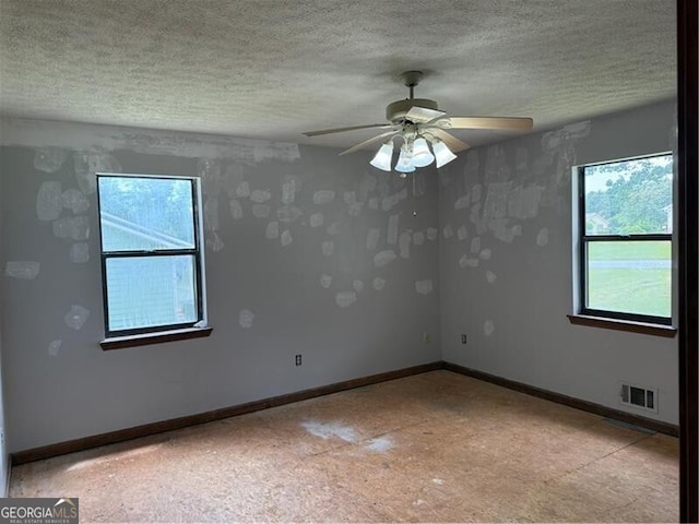 285 Woodland St, Dallas, GA 30157 - empty room featuring ceiling fan, a textured ceiling, and baseboards