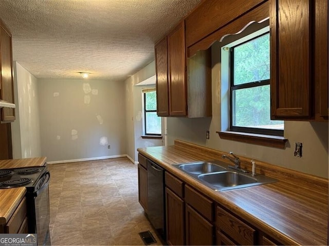 285 Woodland St, Dallas, GA 30157 - kitchen featuring a sink, a textured ceiling, black appliances, and baseboards