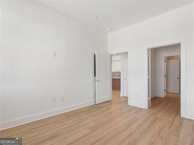 675 Drewry St NE Unit 205, Atlanta, GA 30306 - unfurnished bedroom featuring light wood-style flooring and baseboards