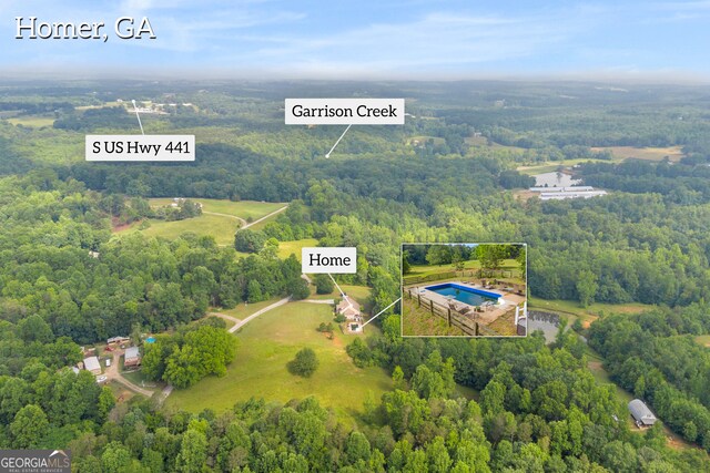152 Charity Dr, Homer, GA 30547 - aerial view of property's location with a heavily wooded area, property parcel outlined, and a pool area