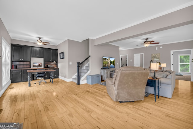152 Charity Dr, Homer, GA 30547 - living area featuring a ceiling fan, stairs, light wood-type flooring, baseboards, and crown molding