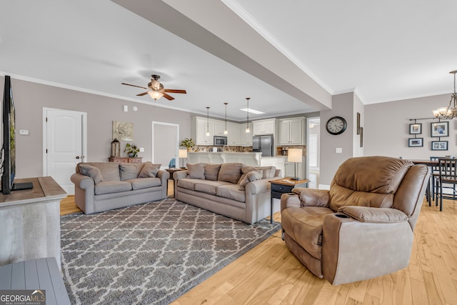 152 Charity Dr, Homer, GA 30547 - living area featuring light wood-style flooring, a chandelier, a ceiling fan, and ornamental molding