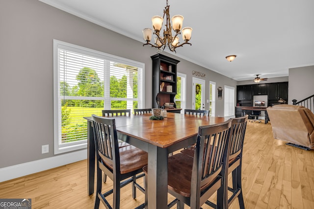 152 Charity Dr, Homer, GA 30547 - dining space with healthy amount of natural light, a chandelier, ornamental molding, light wood-type flooring, and baseboards