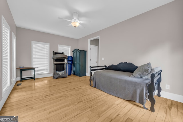 152 Charity Dr, Homer, GA 30547 - bedroom with light wood-type flooring, baseboards, multiple windows, and a ceiling fan