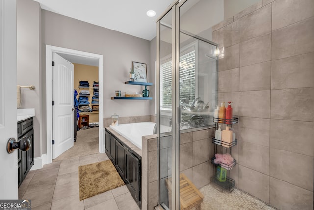 152 Charity Dr, Homer, GA 30547 - full bath featuring a stall shower, a bath, tile patterned floors, and a walk in closet