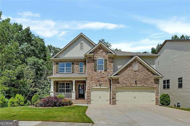 204 Starwood Ct, Acworth, GA 30102 - craftsman-style home with driveway, stone siding, a front lawn, board and batten siding, and covered porch