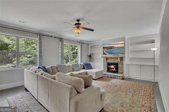 204 Starwood Ct, Acworth, GA 30102 - living room with baseboards, a ceiling fan, built in shelves, a stone fireplace, and wood finished floors