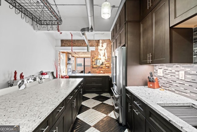 87 Peachtree St SW Unit 209, Atlanta, GA 30303 - kitchen featuring high end fridge, dark flooring, tasteful backsplash, and light stone countertops