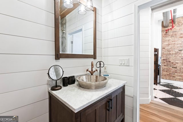 87 Peachtree St SW Unit 209, Atlanta, GA 30303 - bathroom featuring vanity, baseboards, and brick wall