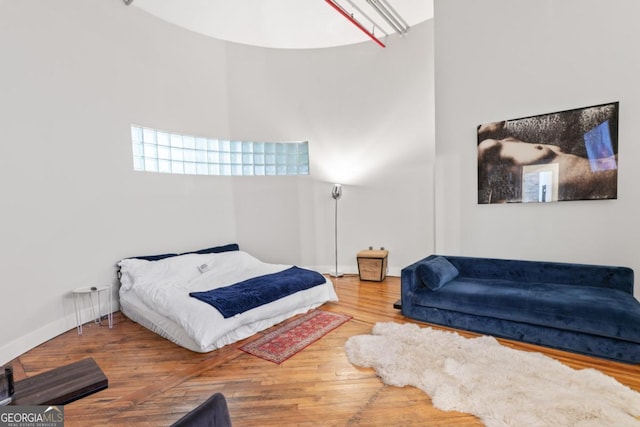 87 Peachtree St SW Unit 209, Atlanta, GA 30303 - bedroom featuring wood finished floors and a high ceiling