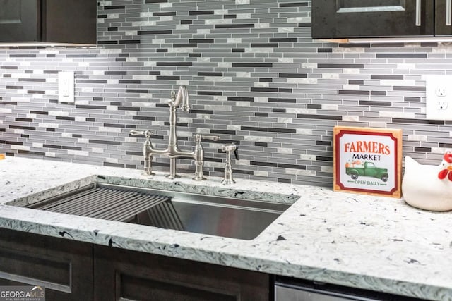 87 Peachtree St SW Unit 209, Atlanta, GA 30303 - kitchen view of a sink, backsplash, and light stone counters