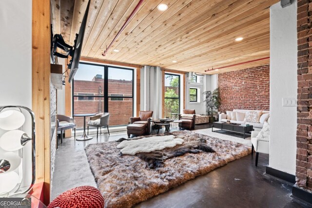 87 Peachtree St SW Unit 209, Atlanta, GA 30303 - living room with finished concrete flooring, wood ceiling, and brick wall