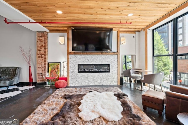 87 Peachtree St SW Unit 209, Atlanta, GA 30303 - living room with wood ceiling, plenty of natural light, a glass covered fireplace, recessed lighting, and finished concrete flooring