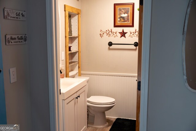 4076 Airline Rd, Mcdonough, GA 30252 - bathroom featuring wainscoting, vanity, toilet, and wood finished floors