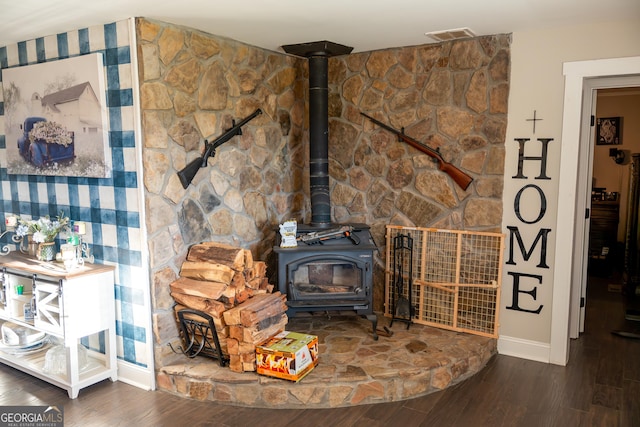 4076 Airline Rd, Mcdonough, GA 30252 - detailed view of baseboards, a wood stove, and wood finished floors