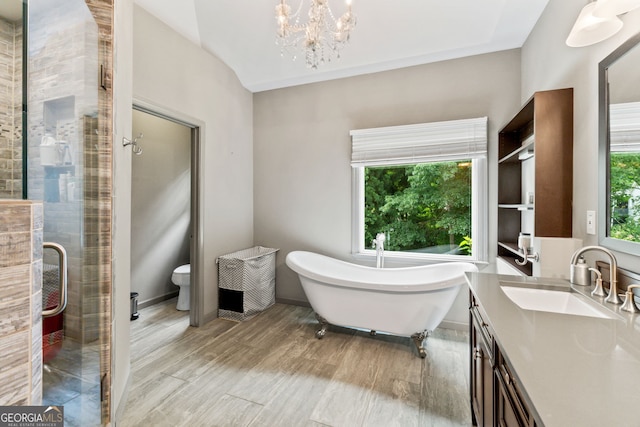 635 Piping Rock Pt, Lawrenceville, GA 30043 - bathroom featuring vanity, a stall shower, a soaking tub, a chandelier, and toilet