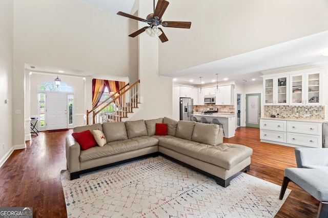 635 Piping Rock Pt, Lawrenceville, GA 30043 - living room with stairway, wood finished floors, a ceiling fan, a towering ceiling, and recessed lighting