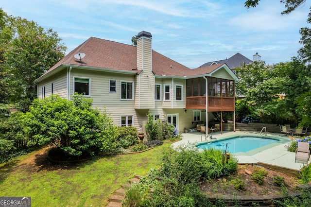 635 Piping Rock Pt, Lawrenceville, GA 30043 - rear view of property with a sunroom, a patio, a chimney, an outdoor pool, and roof with shingles