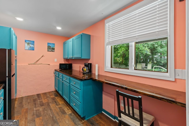 635 Piping Rock Pt, Lawrenceville, GA 30043 - kitchen with blue cabinets, freestanding refrigerator, dark countertops, dark wood-style floors, and recessed lighting