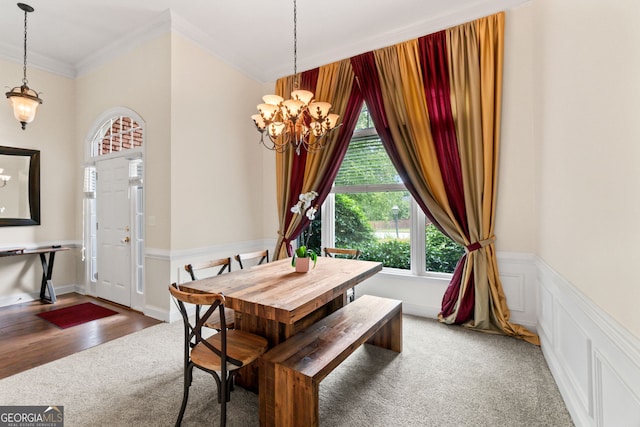 635 Piping Rock Pt, Lawrenceville, GA 30043 - dining area with carpet floors, crown molding, and a chandelier