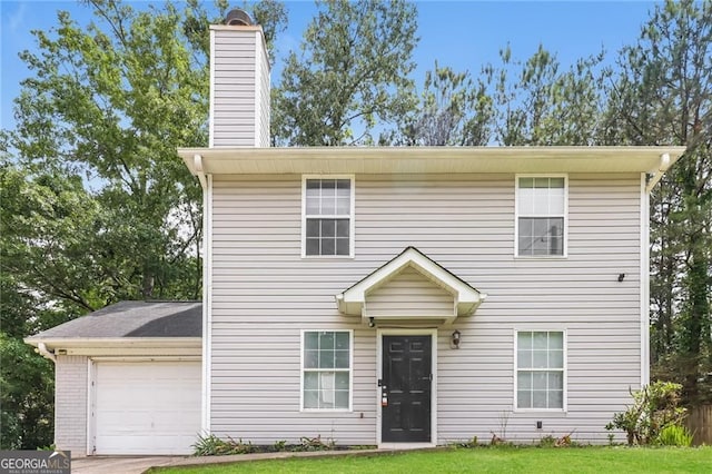 5229 Kirk Dr, Atlanta, GA 30349 - traditional home with a chimney, an attached garage, and a front lawn
