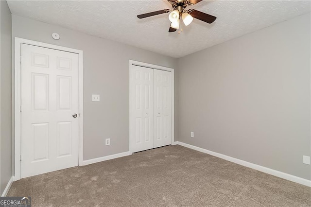 5229 Kirk Dr, Atlanta, GA 30349 - unfurnished bedroom featuring carpet flooring, a textured ceiling, a closet, and baseboards