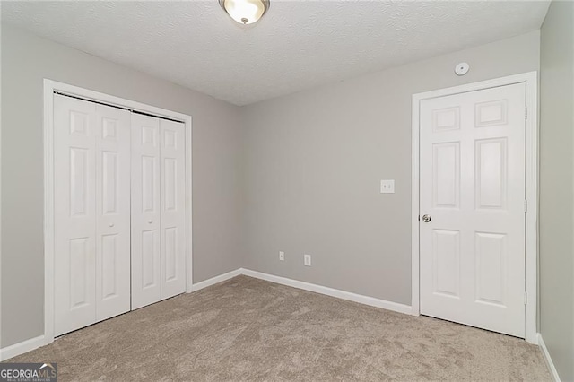5229 Kirk Dr, Atlanta, GA 30349 - unfurnished bedroom with carpet, a closet, baseboards, and a textured ceiling