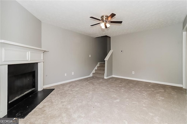 5229 Kirk Dr, Atlanta, GA 30349 - unfurnished living room featuring a fireplace, a ceiling fan, carpet floors, stairs, and baseboards