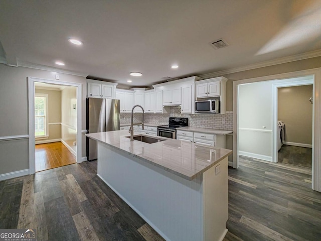 34 Alan Ln Unit 7, Tifton, GA 31793 - kitchen with stainless steel appliances, a sink, crown molding, washer and dryer, and white cabinets