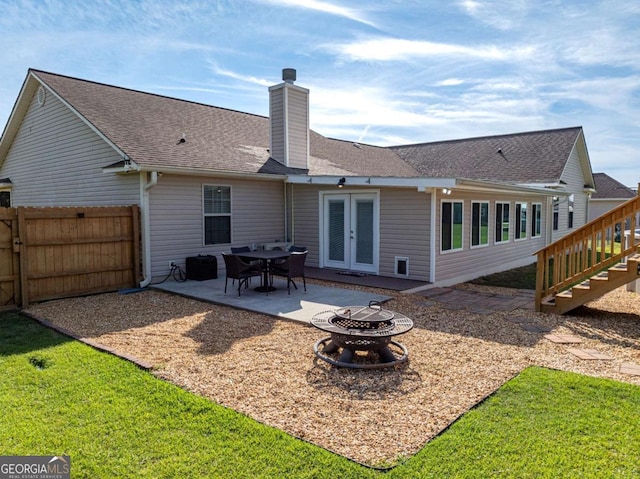 34 Alan Ln Unit 7, Tifton, GA 31793 - rear view of property featuring an outdoor fire pit, a chimney, a patio, stairway, and french doors