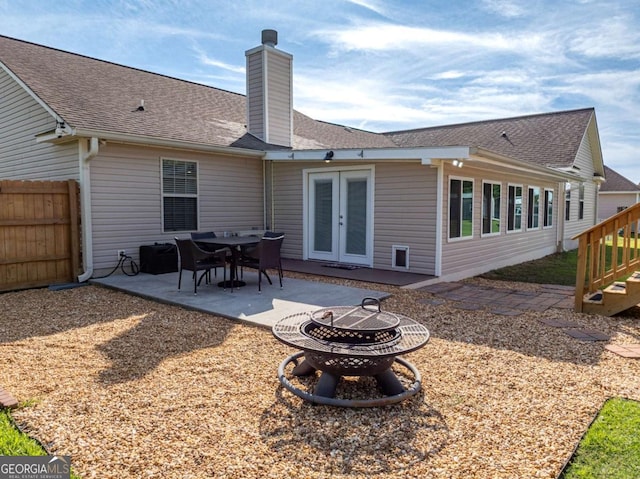 34 Alan Ln Unit 7, Tifton, GA 31793 - rear view of house with an outdoor fire pit, french doors, a chimney, a patio area, and roof with shingles