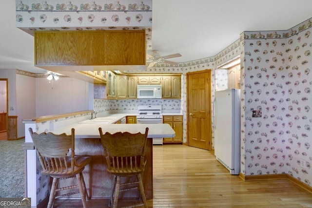 156 Spoon Hill Dr, Hayesville, NC 28904 - kitchen featuring white appliances, a ceiling fan, a peninsula, light wood finished floors, and wallpapered walls