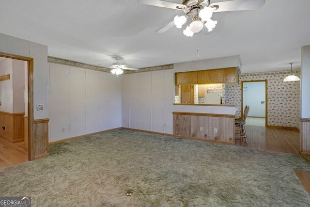 156 Spoon Hill Dr, Hayesville, NC 28904 - unfurnished living room featuring a ceiling fan, carpet flooring, and wood finished floors