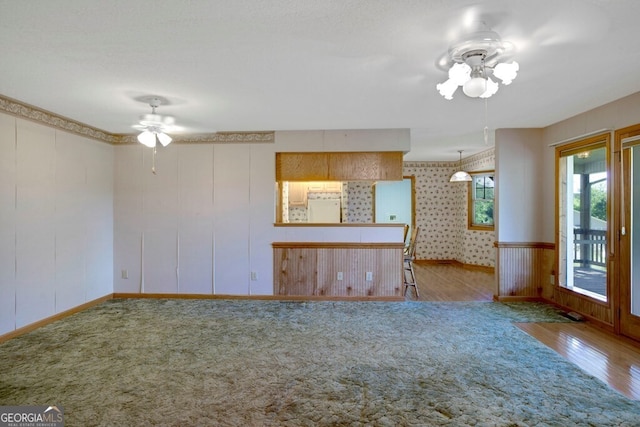 156 Spoon Hill Dr, Hayesville, NC 28904 - unfurnished living room featuring ceiling fan, baseboards, wood finished floors, and carpet flooring