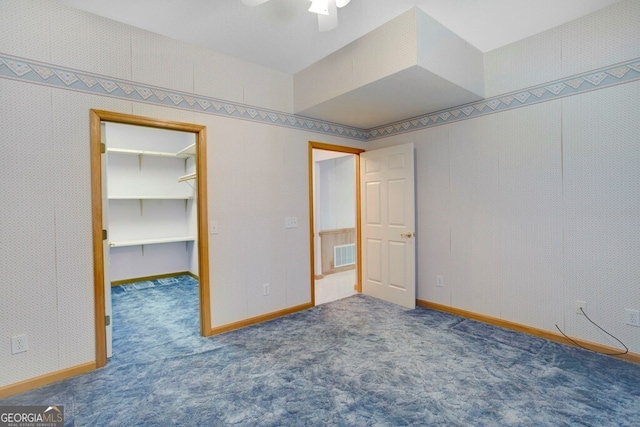 156 Spoon Hill Dr, Hayesville, NC 28904 - unfurnished bedroom with a spacious closet, carpet floors, baseboards, and ceiling fan